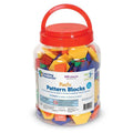 Clear plastic bucket with a red handle filled with colorful yellow, orange, blue, and red geometric pattern blocks.