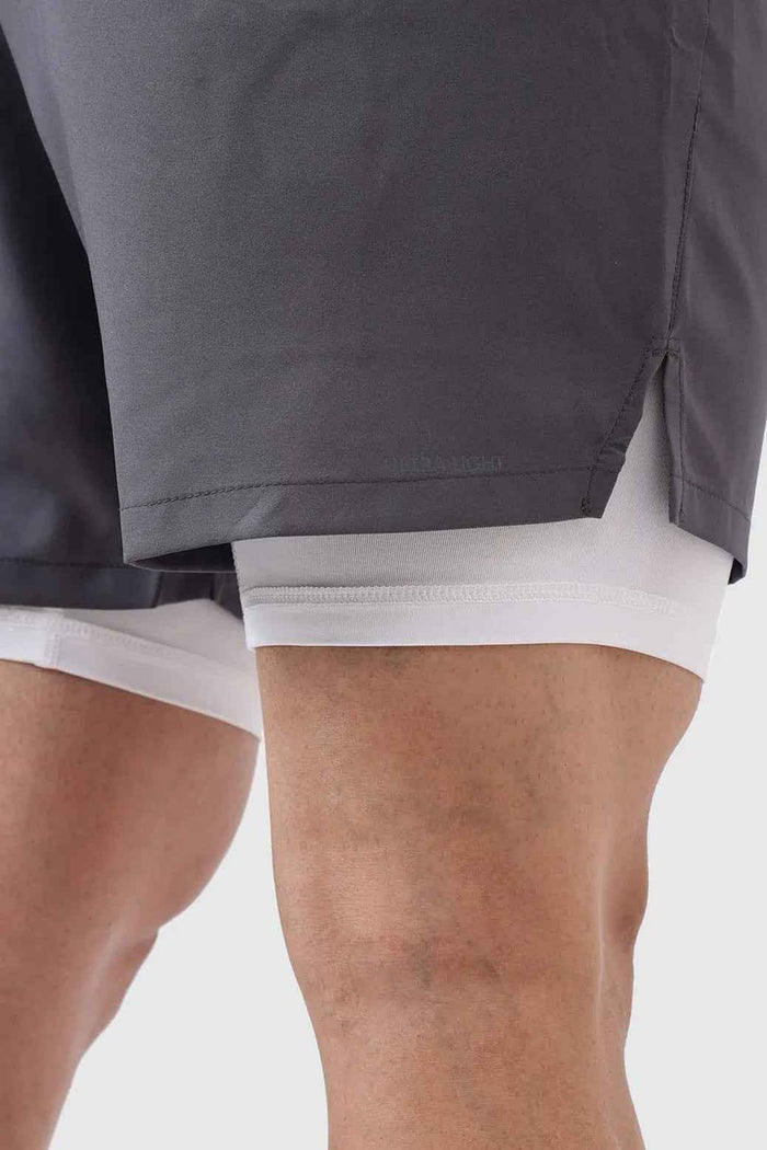 Fuaark Nz 2-in-1 compression shorts in grey with white accents, designed for athletic performance and comfort.