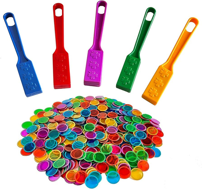 Five colorful magnetic wands above a large pile of translucent, multicolored round chips.