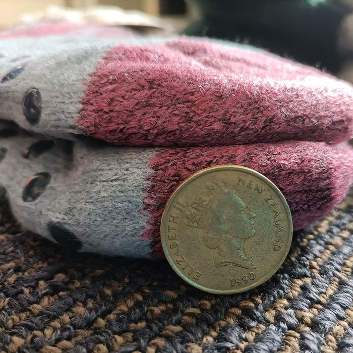 Pair of fuzzy kids' winter slippers with grippers from dealonline.co.nz, featuring soft, warm fabric and non-slip soles.