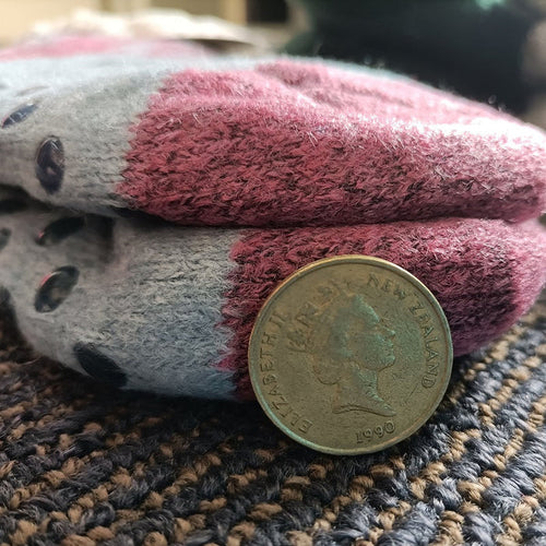 Pair of fuzzy kids' winter slippers with grippers from dealonline.co.nz, featuring soft, warm fabric and non-slip soles.
