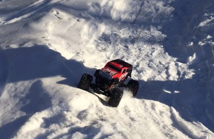 Red and black 2.4G 4WD amphibious RC crawler buggy car with rugged tires and waterproof design, ideal for off-road and water play.