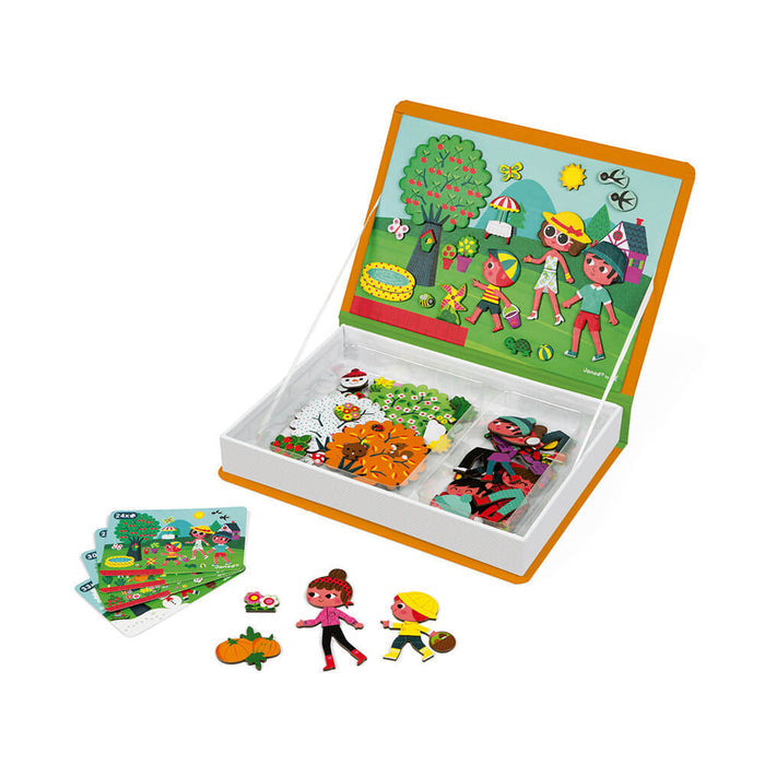 Orange book-shaped toy box open to a magnetic garden scene with character magnets and seasonal play pieces.