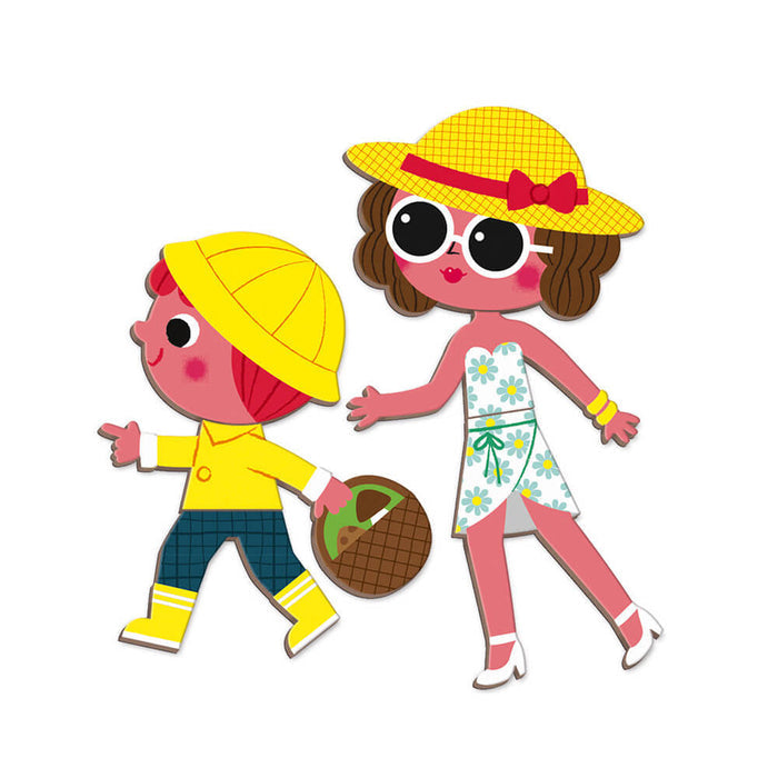 Magnetic toy characters of a woman and child in summer outfits, featuring yellow hats and a picnic basket.