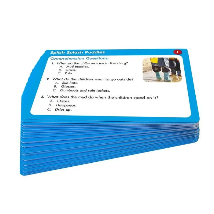 Stack of blue educational cards with multiple-choice comprehension questions and a photo of kids in rain boots.