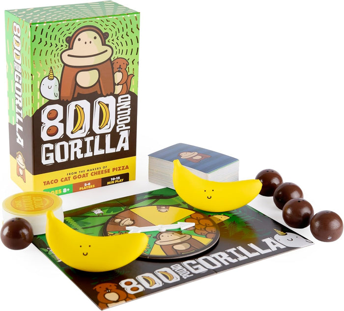 Green 800 Pound Gorilla game box with cards, spinner board, yellow banana pieces, and brown spherical tokens.