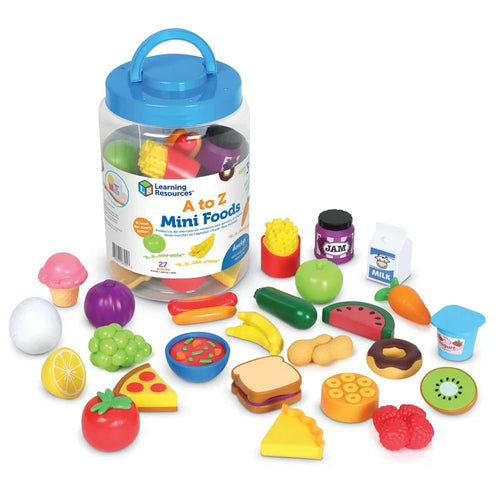 Clear plastic jar with blue lid surrounded by colorful toy food miniatures of fruits, vegetables, and snacks.