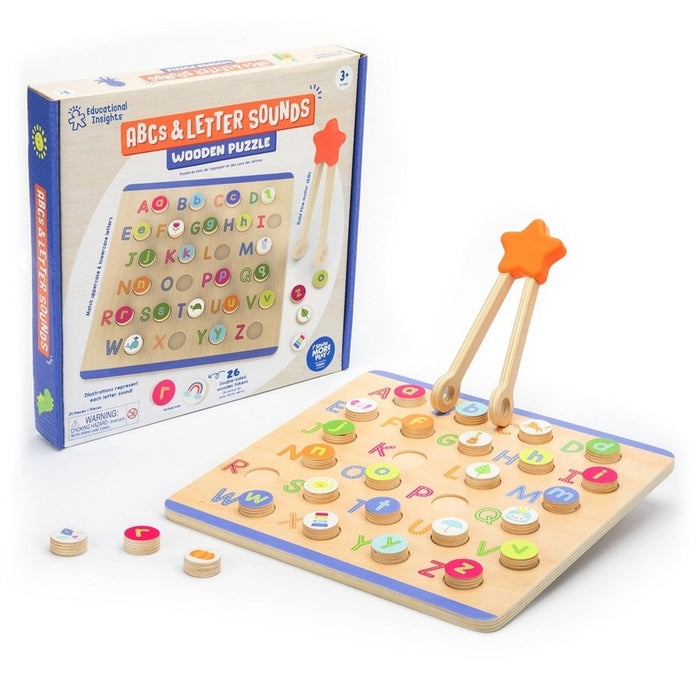 Wooden alphabet puzzle board with colorful tokens, star-topped tweezers, and illustrated product packaging.