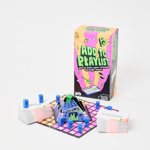 Colorful music board game box, game board with pop-up speakers, blue smiley character pieces, and card decks.
