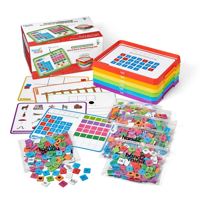 Phonics kit with six stacked rainbow trays, activity boards, and bags of colorful magnetic letter and phonics tiles.