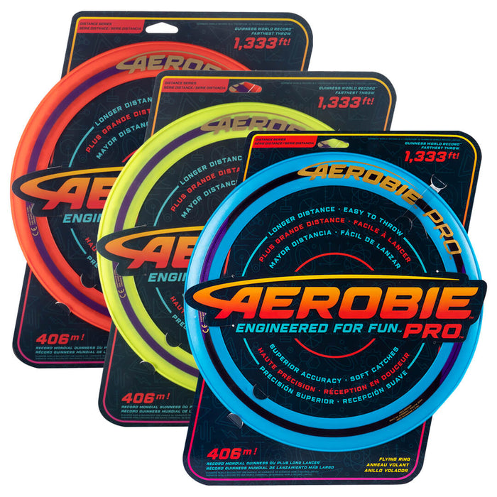 Three large flying rings in orange, yellow, and blue, each on a black retail display card.