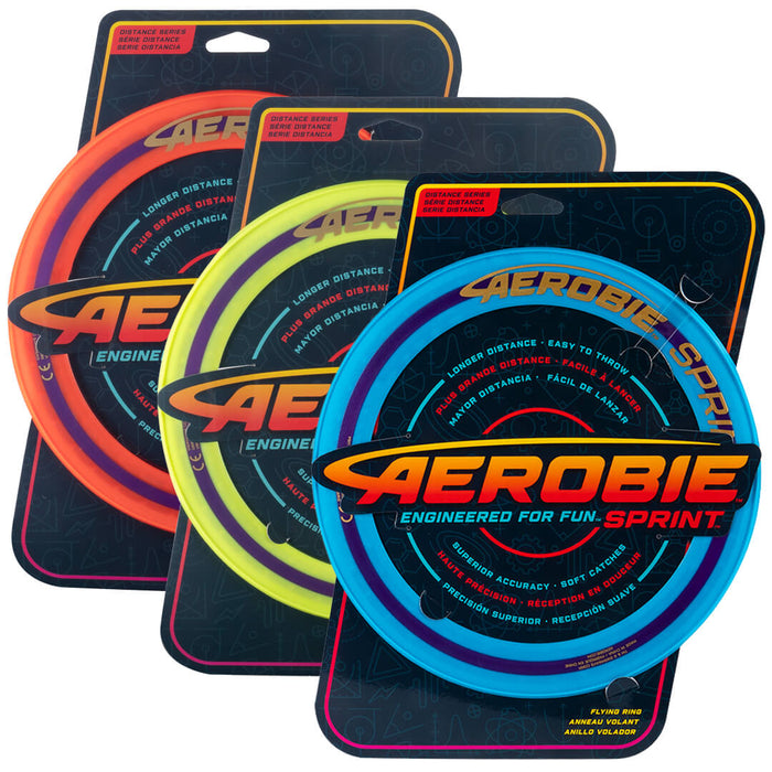 Three circular flying rings in orange, yellow, and blue, displayed in their branded cardboard retail packaging.