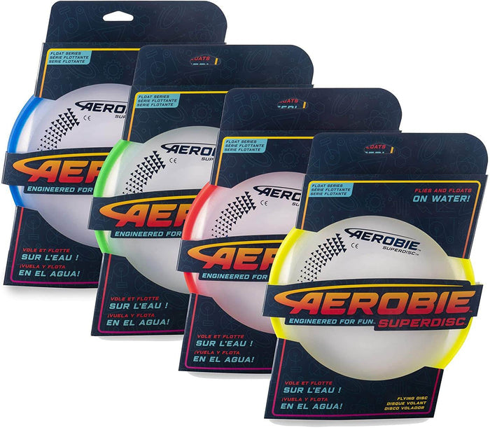 Four circular flying discs with blue, green, red, and yellow soft rims in retail packaging that float on water.