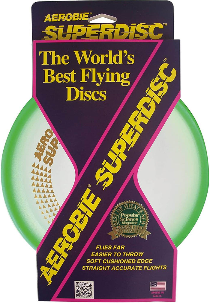 Aerobie Superdisc flying disc with a green cushioned rim and clear center in purple and yellow cardboard packaging.