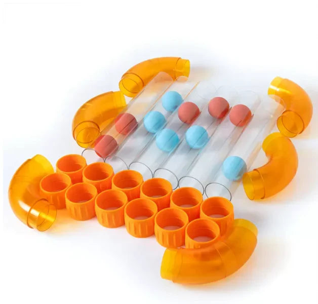 Translucent orange curved tubes, connectors, clear straight tubes, and blue and orange foam balls on white background.