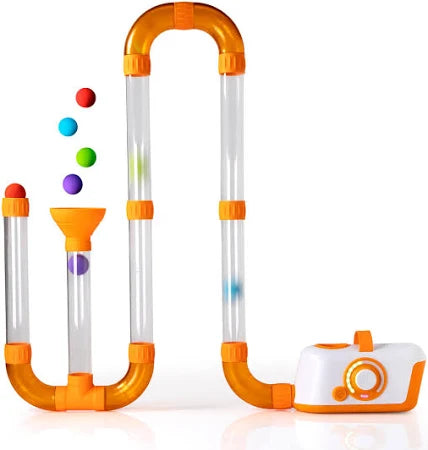 Modular clear tubes with orange joints and an air blower base. Colorful foam balls travel through the winding path.