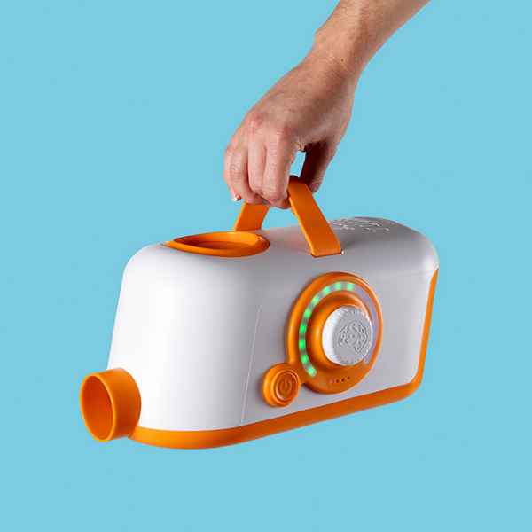 Hand holds a white and orange air blower toy with a nozzle, handle, and light-up dial against a blue background.
