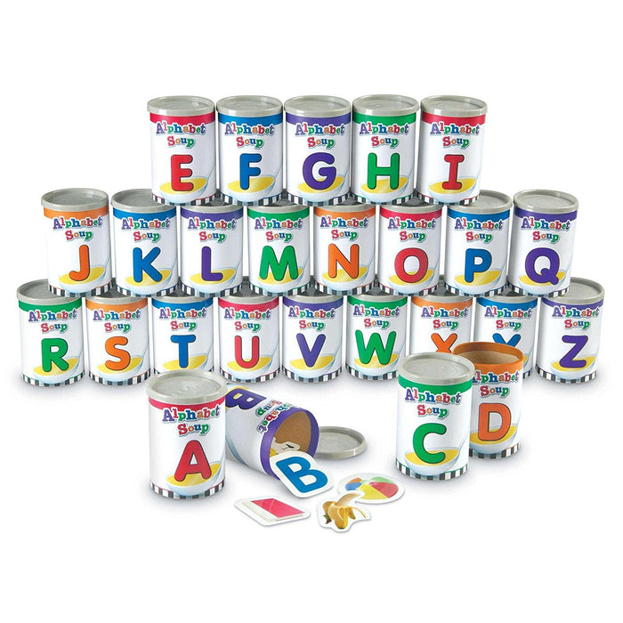 26 colorful toy soup cans labeled A to Z. Open cans show letter pieces and object cutouts like a banana and beach ball.