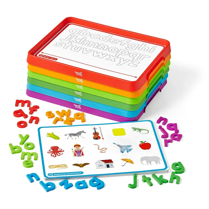 Stacked colorful trays with alphabet cards, scattered plastic letters, and a picture matching activity card.