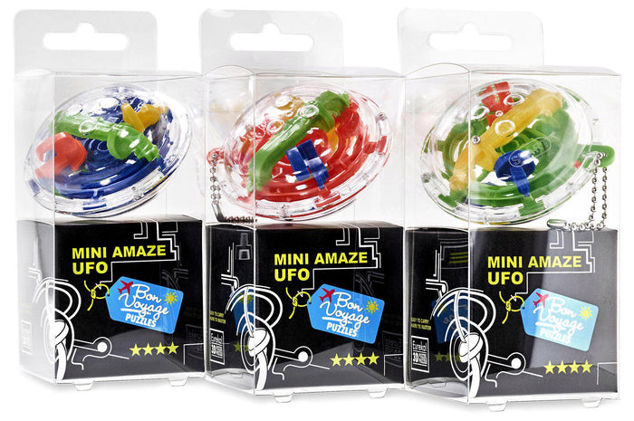 Three disc-shaped 3D maze puzzles in clear boxes with colorful internal tracks and silver keychains.