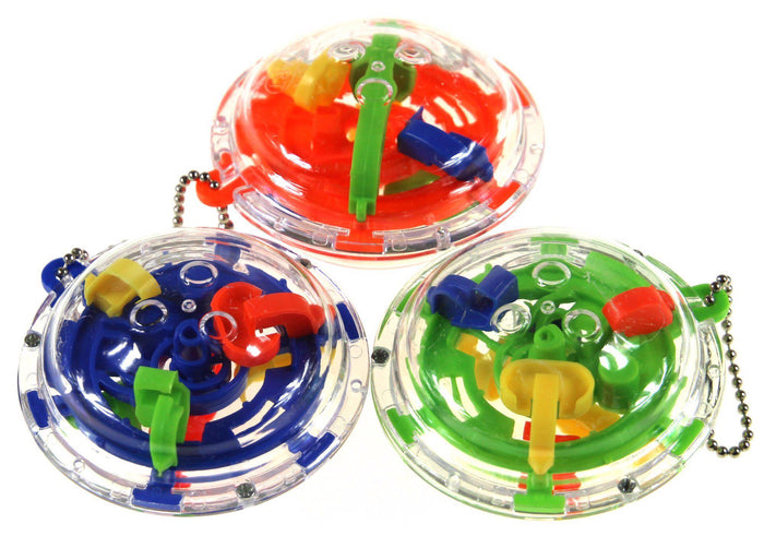 Three colorful UFO-shaped maze puzzles with clear domes, internal tracks, and silver ball chain keychains.