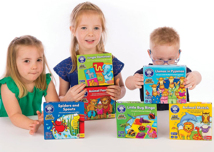 Three children with Orchard Toys mini games, including a yellow Animal Match box featuring a cartoon lion and dolphin.