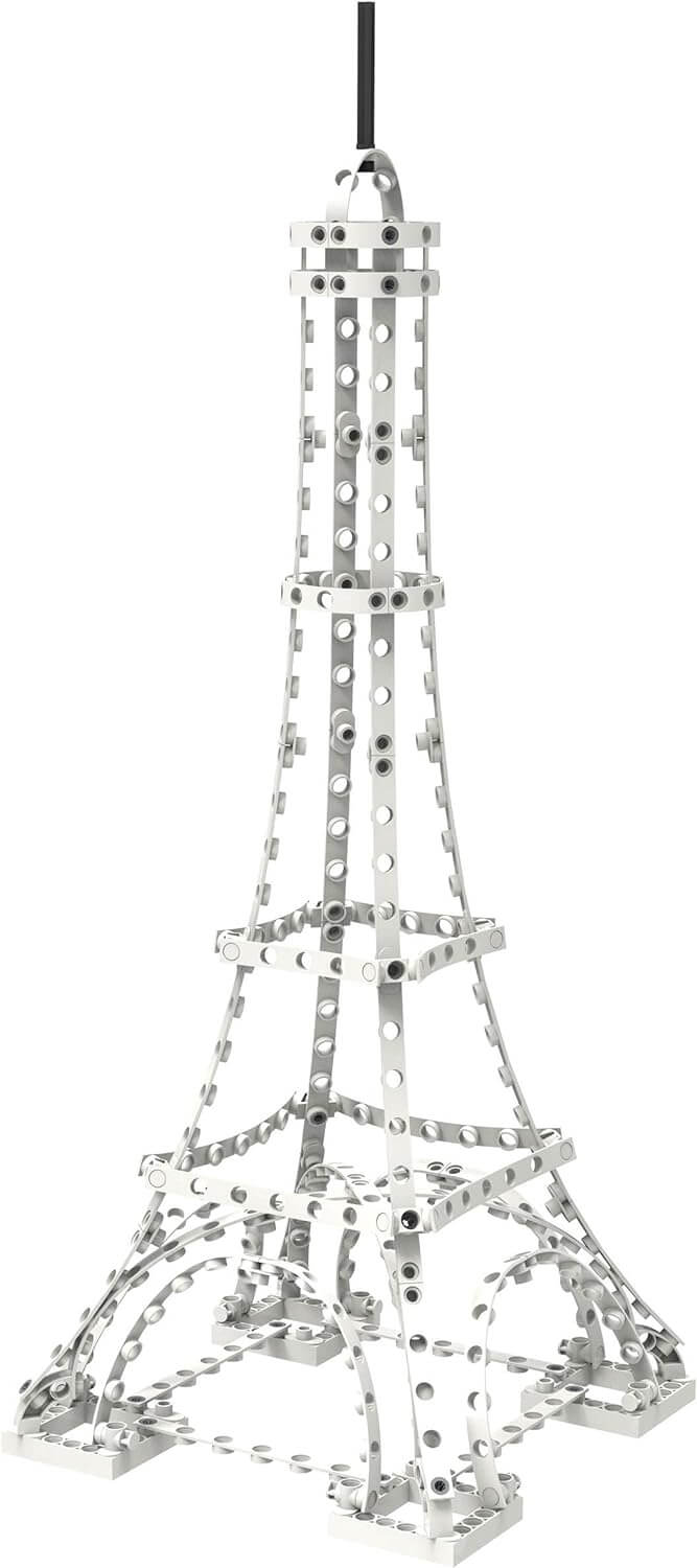White plastic Eiffel Tower model with an open lattice structure, built from an engineering toy construction set.