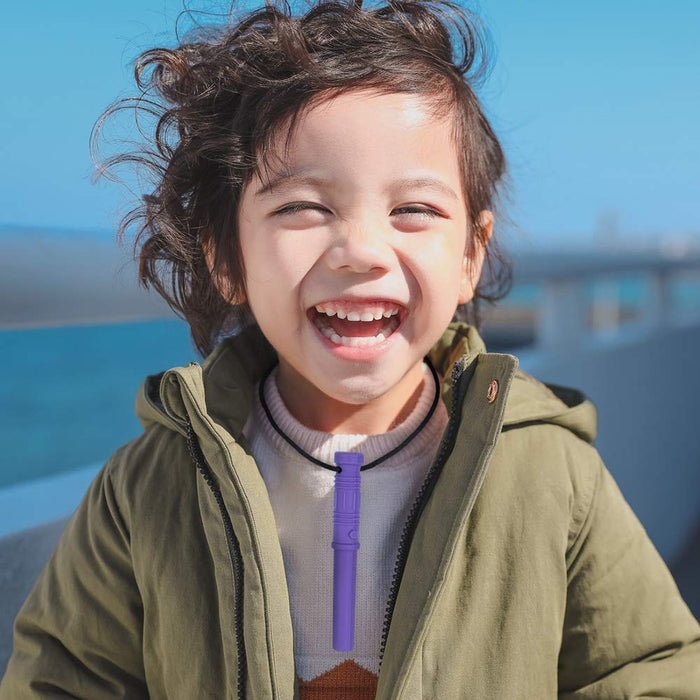 Laughing child wearing a purple lightsaber-shaped sensory chew pendant on a black cord necklace.
