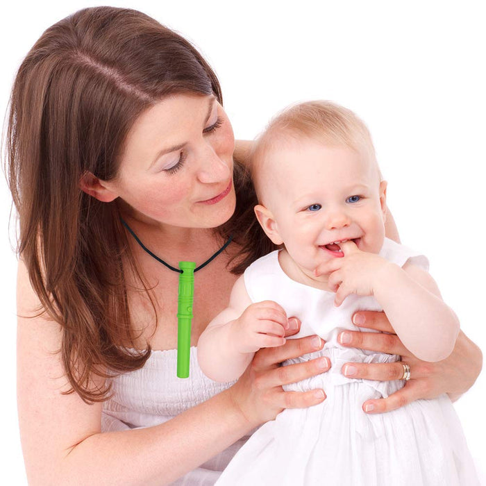 A bright green saber-shaped sensory chew necklace worn by a mother holding her smiling baby.