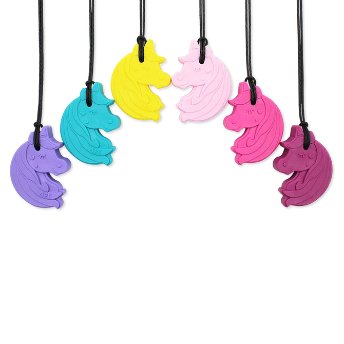 Six unicorn-head sensory chew pendants in various colors, hanging from black cords in a semi-circle.