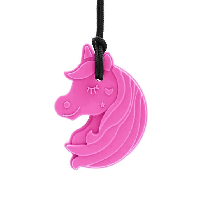 Bright pink silicone unicorn head pendant with star and heart details hanging from a black cord.
