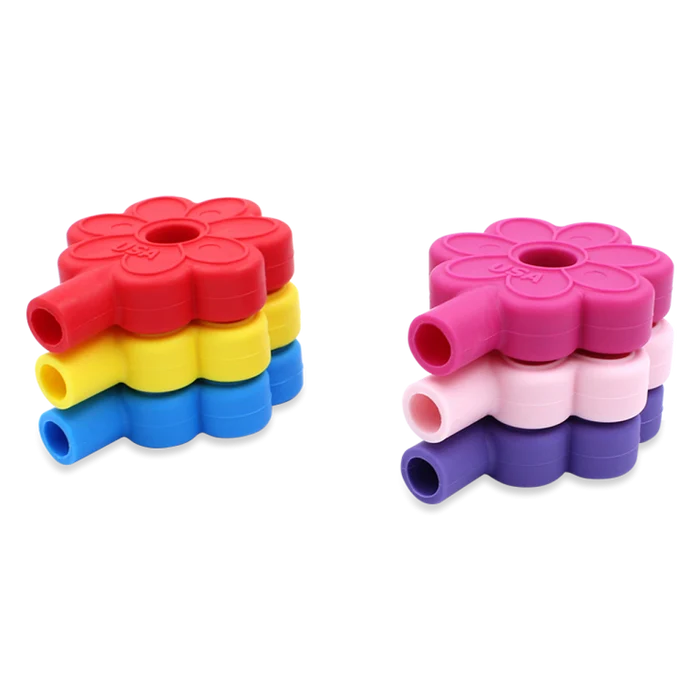 Six silicone flower-shaped pencil toppers in red, yellow, blue, pink, and purple, stacked in two groups.