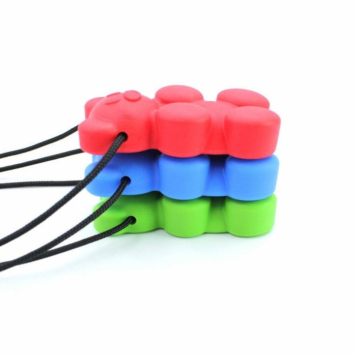 Stack of red, blue, and green gummy bear shaped chewable pendants with black necklace cords.