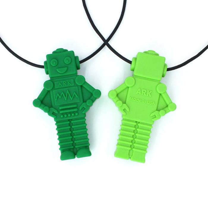 Dark and lime green robot-shaped sensory pendants on black cords, showing textured front and back details.