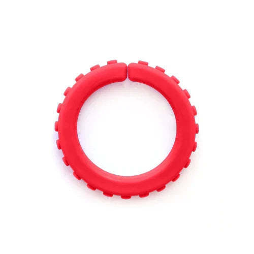 Red circular sensory chew bracelet with textured brick-like bumps on the outer edge and a small gap at the top.
