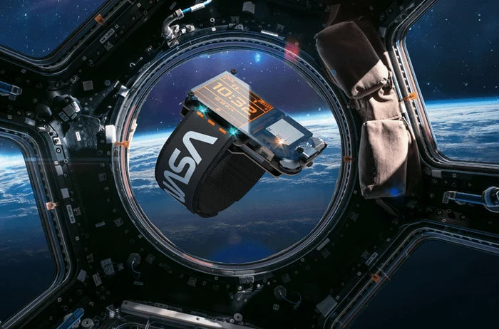 A black NASA digital watch with an orange display floats inside a spacecraft window showing Earth and outer space.