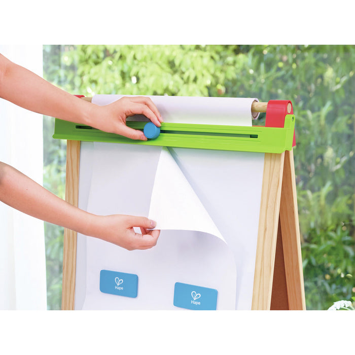Wooden easel with a paper roll, a green horizontal bar with a blue slider, and two blue magnetic clips.