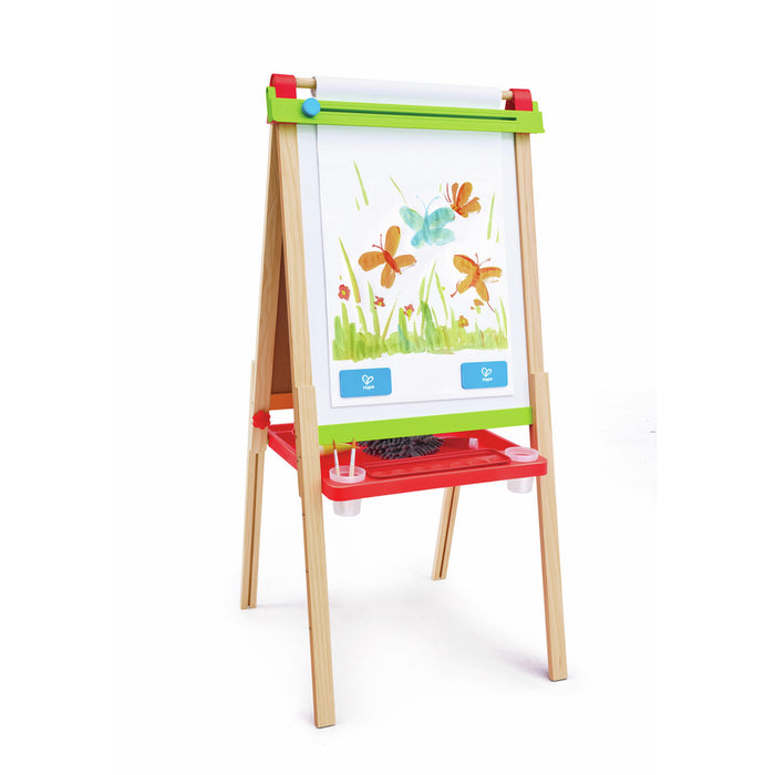 Adjustable wooden kids' easel with a paper roll, green trim, and red tray with brushes and a butterfly painting.