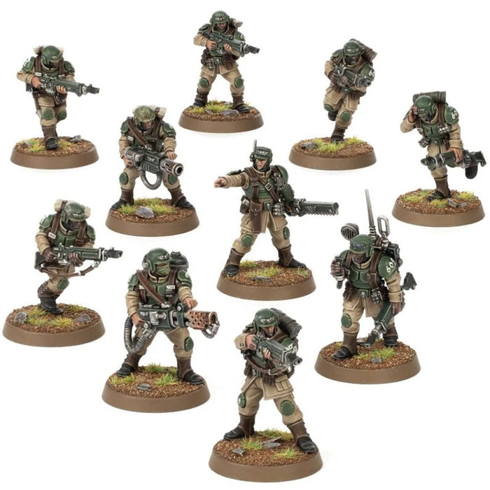 Ten painted miniature soldiers in tan fatigues and green armor holding rifles and equipment on round textured bases.