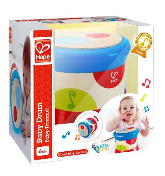 Toy drum in packaging showing a baby playing, with a blue rim, wooden top, and colorful musical note patterns.