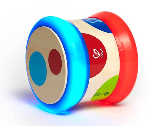 Wooden baby drum toy featuring a glowing blue circular end, a red end, and colorful shapes on the white body.