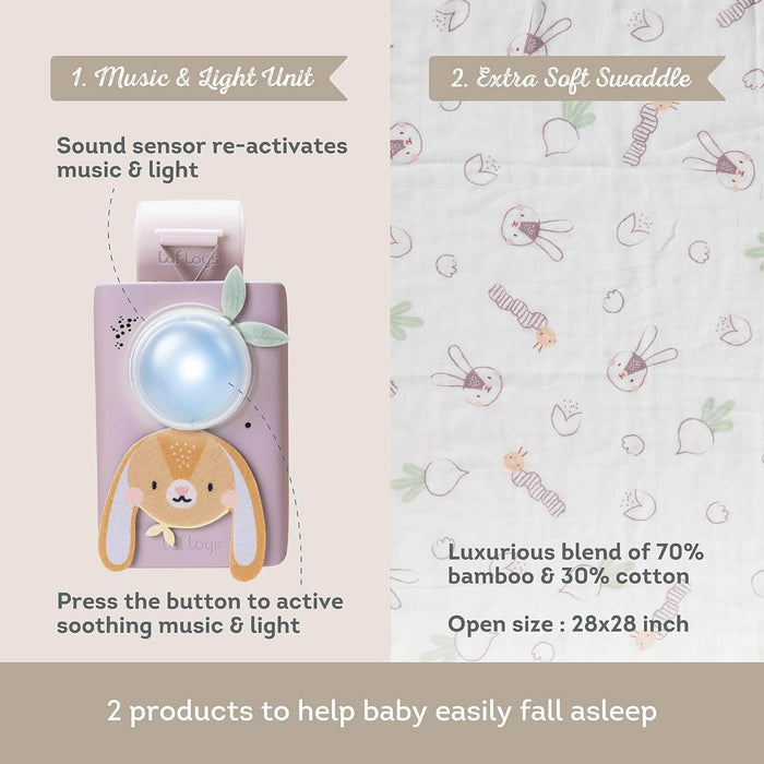 Purple bunny sound machine with a glowing light and a white swaddle blanket featuring animal and carrot prints.