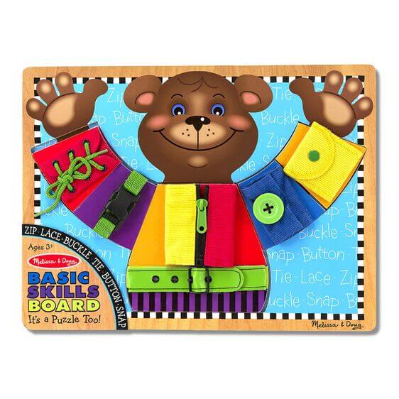 Bear-shaped wooden puzzle with colorful fabric panels for practicing zipping, snapping, lacing, and buckling.