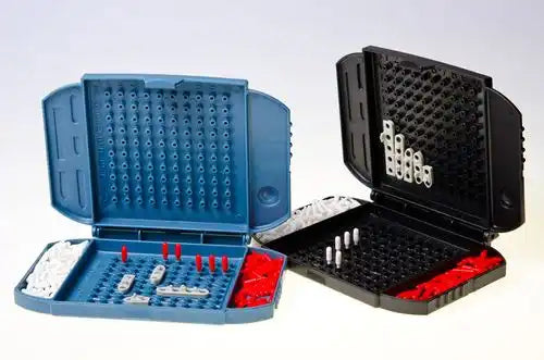 Blue and black portable Battleship game cases open with tiny ships and red and white pegs on grid boards.