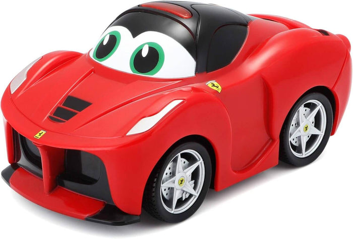 Bright red toy car with large green cartoon eyes on the windshield and silver wheels with the Ferrari logo.