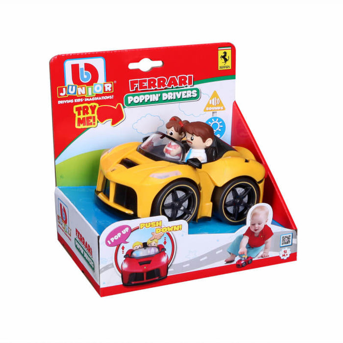 Yellow toy Ferrari with driver figures in a red BB Junior box showing pop-up play and sound features.
