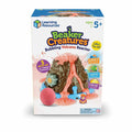 Box for a brown toy volcano with bubbling orange foam, a pink round pod, and small colorful plastic monster figures.