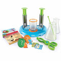 Science kit with blue reactor, green plungers, beakers, tongs, creature pods, and mini figurines.