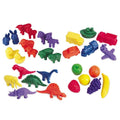 Colorful plastic sorting counters shaped like farm animals, dinosaurs, vehicles, and fruit on a plain white background.