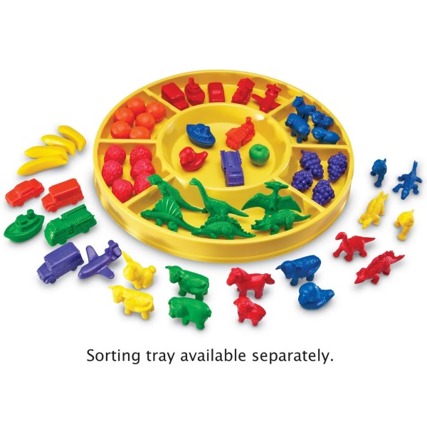 Assorted colorful plastic counters shaped like animals, fruit, and vehicles in and around a yellow circular sorting tray.